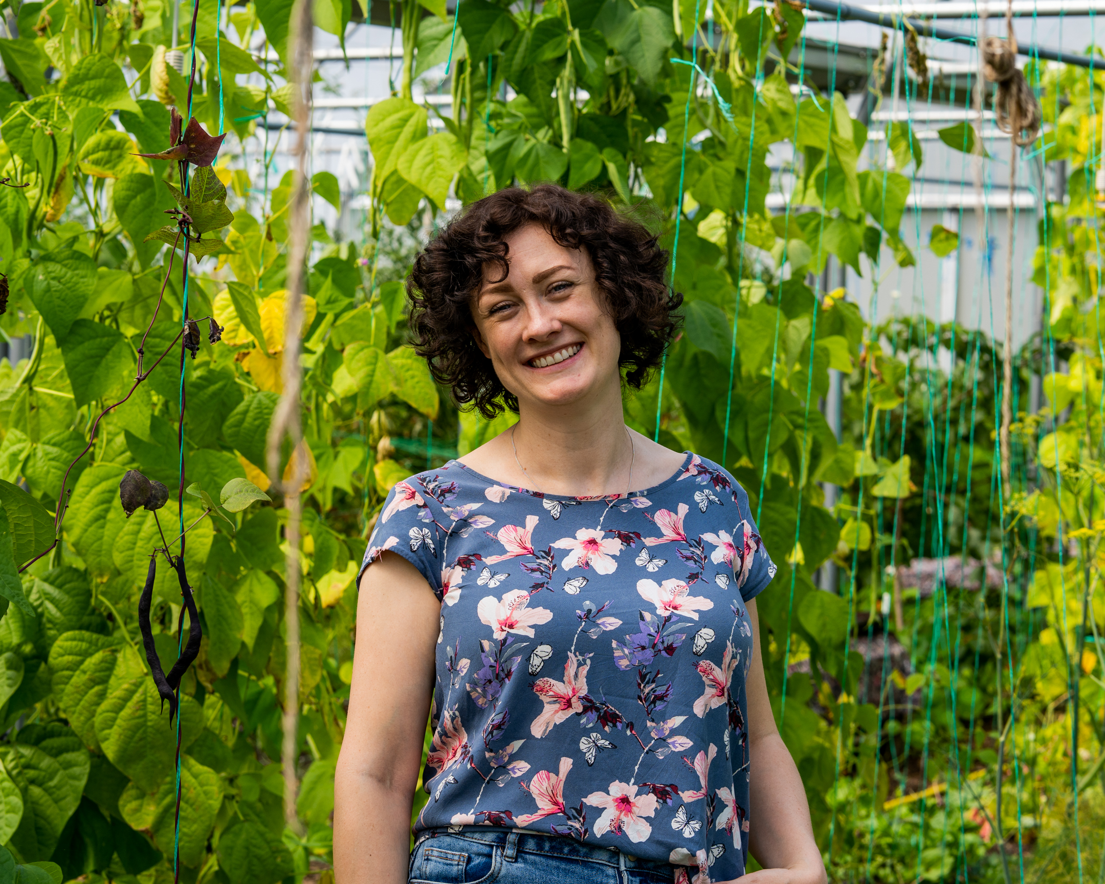 Jocelyn Doyle headshot against leafy background