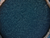 Overhead shot of an open ocean salmon farm with fish swimming in circles