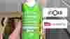 A hand holding a green carton of fresh French apple juice on board a Newrest Wagons Lits train