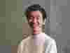 Hideaki Omote of KIGI restaurant, Tokyo, smiling against a grey background