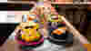 Colourful dishes of sushi on conveyor belt at Yo! Sushi