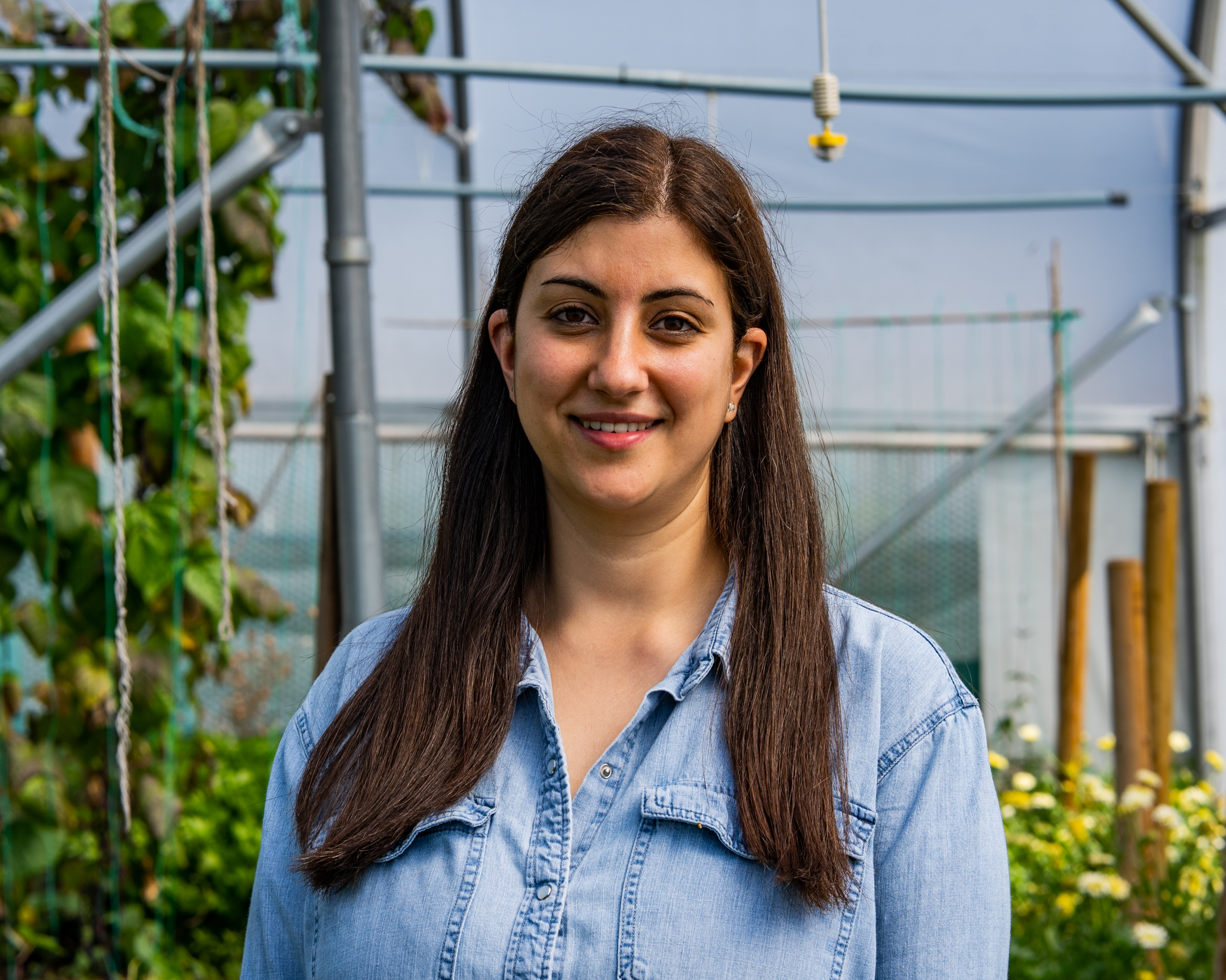 Agatha Georgiou headshot against leafy background