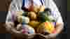 Chef holding pumpkins and squashes of all different sizes and colours