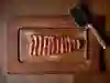 Overhead shot of a sliced steak on wooden board with a cleaver to the top right of the shot