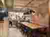Apricity restaurant interior, with pink and gold decor and busy open kitchen in the background