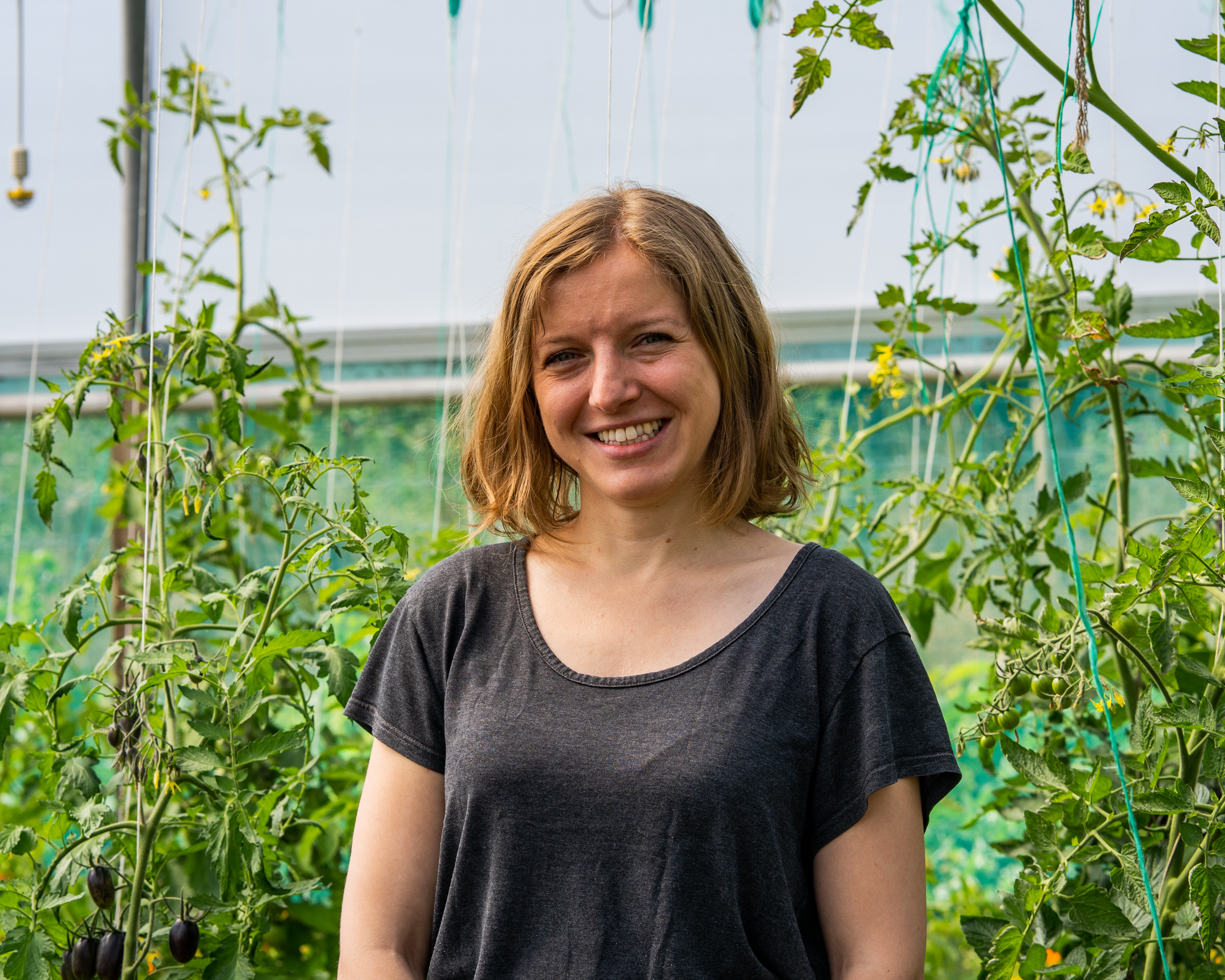 Julia Holiday headshot against leafy background