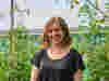 Julia Holiday headshot against leafy background
