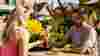 A couple enjoying a drink together in a sunny Wells & Co. beer garden